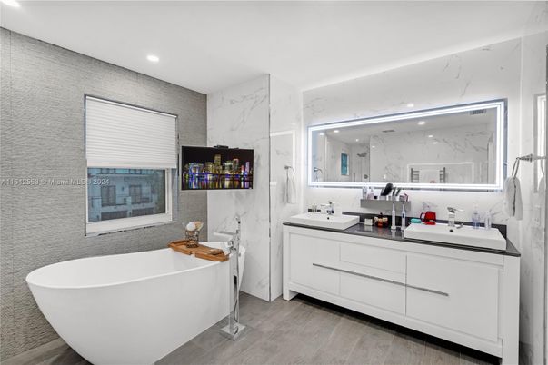 Bathroom, Dual Sink Vanities, Free Standing Baths, Interior, Marble Walls, Recessed Lighting, Wood Texture Flooring