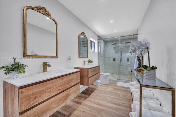 Bathroom, Dual Sink Vanities, Glass Shower, Interior, Marble Walls, Recessed Lighting, Wood Texture Flooring