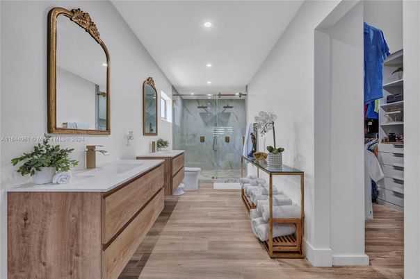 Bathroom, Dual Sink Vanities, Glass Shower, Interior, Marble Walls, Recessed Lighting, Wood Texture Flooring