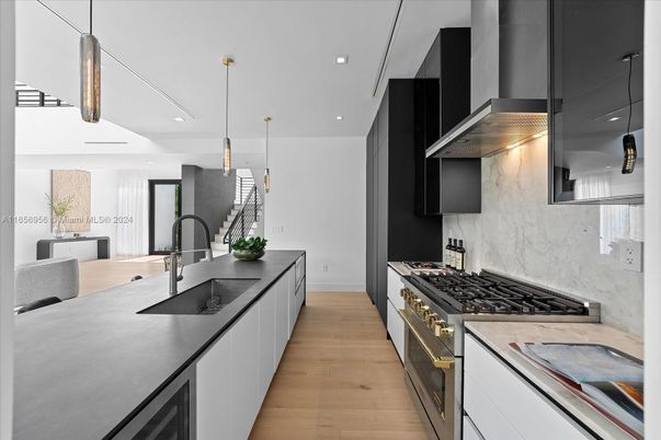 Interior, Kitchen, Marble Walls, Pendant Lights, Recessed Lighting, Stainless Steel Appliances, Wood Texture Flooring
