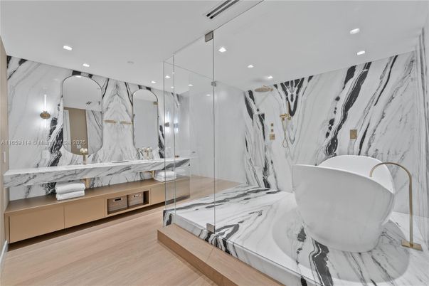 Bathroom, Free Standing Baths, Glass Shower, Interior, Marble, Marble Walls, Recessed Lighting, Wood Texture Flooring