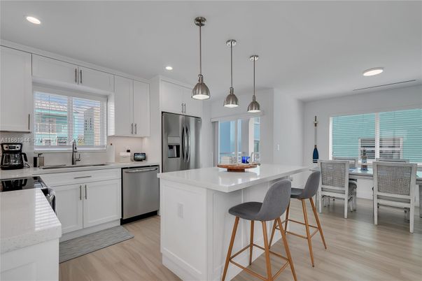 Dining room, Interior, Kitchen, Pendant Lights, Recessed Lighting, Stainless Steel Appliances, Wood Texture Flooring