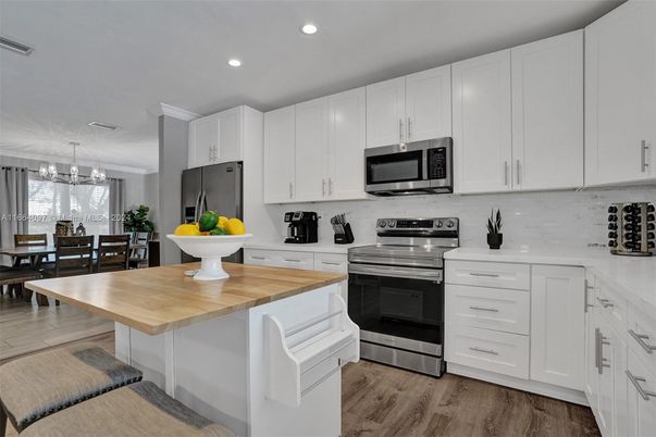 Dining room, Interior, Kitchen, Pendant Lights, Recessed Lighting, Stainless Steel Appliances, Wood Texture Flooring