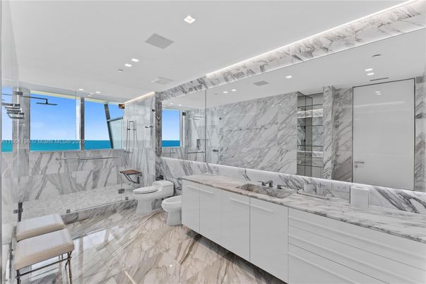Bathroom, Dual Sink Vanities, Glass Shower, Interior, Marble, Marble Walls, Recessed Lighting, Water