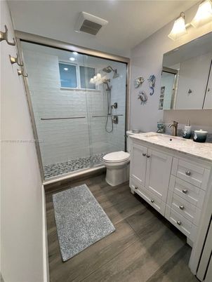 Bathroom, Dual Sink Vanities, Glass Shower, Interior, Recessed Lighting, Wood Texture Flooring