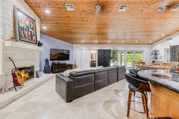 Dining room, Fireplace, Interior, Living room, Recessed Lighting, Stone Walls, Wooden Ceilings