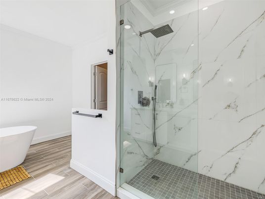 Bathroom, Free Standing Baths, Glass Shower, Interior, Marble Walls, Recessed Lighting, Wood Texture Flooring