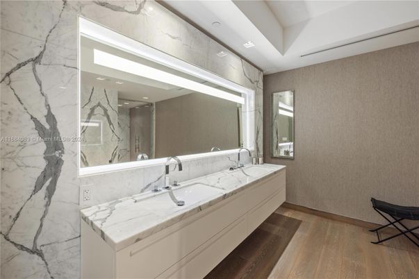 Bathroom, Dual Sink Vanities, Interior, Marble Walls, Recessed Lighting, Wood Texture Flooring