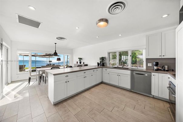 Dining room, Interior, Kitchen, Pendant Lights, Recessed Lighting, Stainless Steel Appliances, Water, Wood Texture Flooring