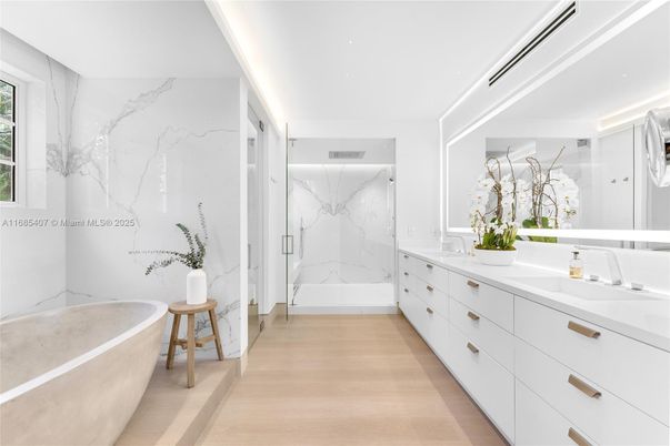 Bathroom, Dual Sink Vanities, Free Standing Baths, Glass Shower, Interior, Marble Walls, Recessed Lighting, Wood Texture Flooring