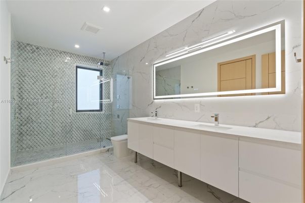 Bathroom, Dual Sink Vanities, Glass Shower, Interior, Marble, Marble Walls, Recessed Lighting