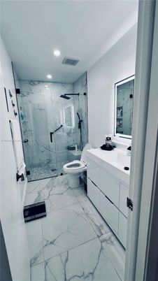 Bathroom, Dual Sink Vanities, Glass Shower, Interior, Marble, Marble Walls, Recessed Lighting