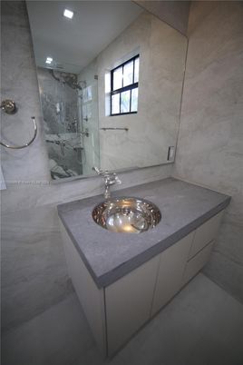 Bathroom, Dual Sink Vanities, Glass Shower, Interior, Marble Walls, Recessed Lighting