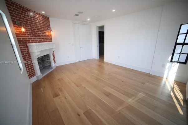 Empty room, Fireplace, Interior, Recessed Lighting, Stone Walls, Wood Texture Flooring
