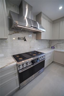 Interior, Kitchen, Marble Walls, Recessed Lighting, Stainless Steel Appliances
