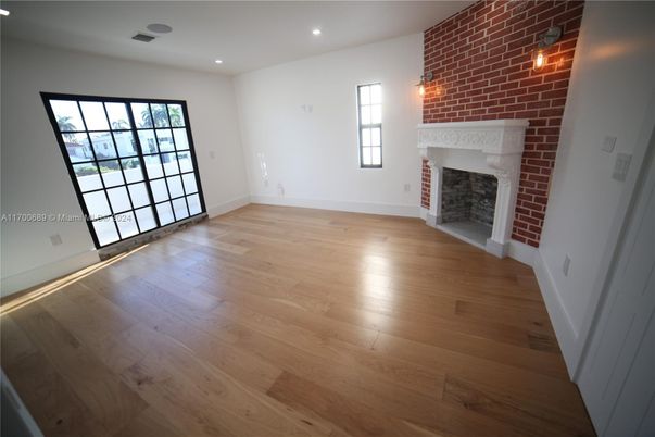 Empty room, Fireplace, Interior, Recessed Lighting, Stone Walls, Wood Texture Flooring