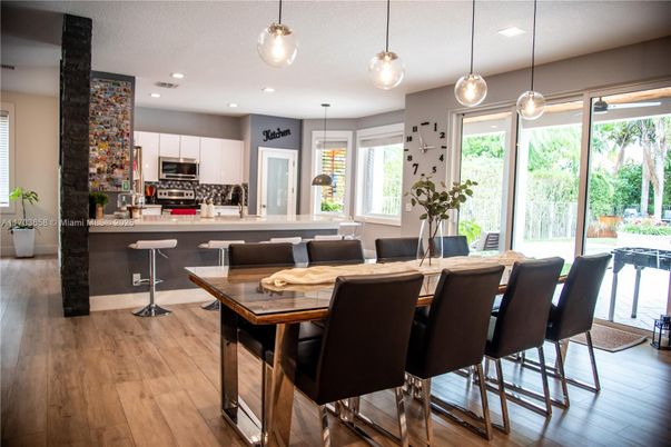 Dining room, Interior, Kitchen, Pendant Lights, Recessed Lighting, Stainless Steel Appliances, Wood Texture Flooring