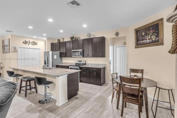Dining room, Interior, Kitchen, Recessed Lighting, Stainless Steel Appliances, Wood Texture Flooring
