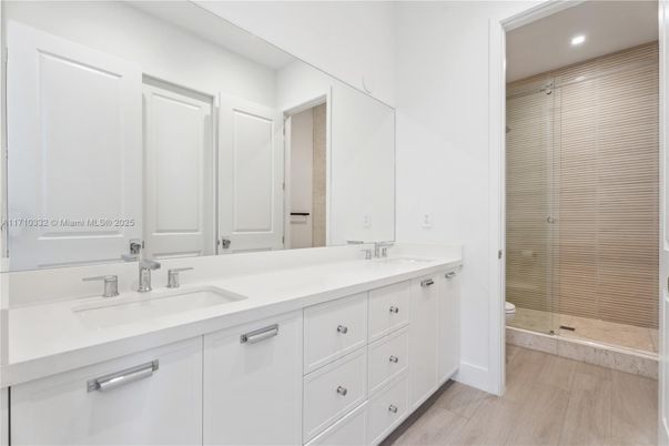 Bathroom, Dual Sink Vanities, Glass Shower, Interior, Recessed Lighting, Wood Texture Flooring