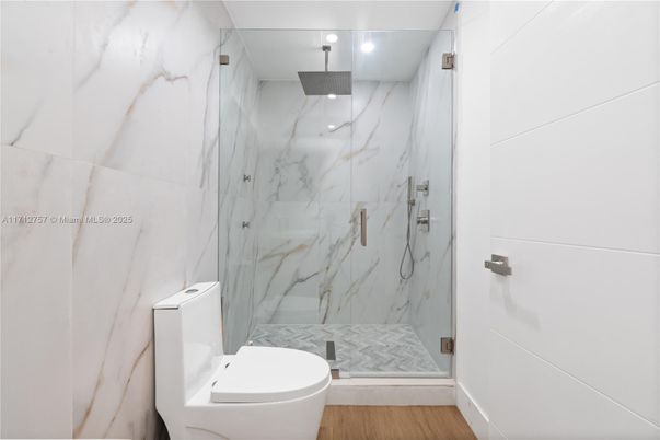 Bathroom, Glass Shower, Interior, Marble Walls, Recessed Lighting, Wood Texture Flooring