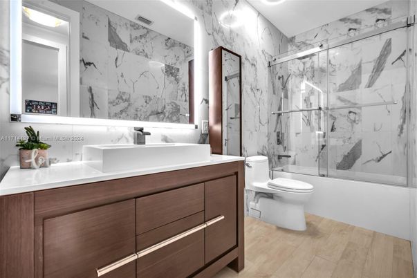 Bathroom, Dual Sink Vanities, Glass Shower, Interior, Marble Walls, Wood Texture Flooring