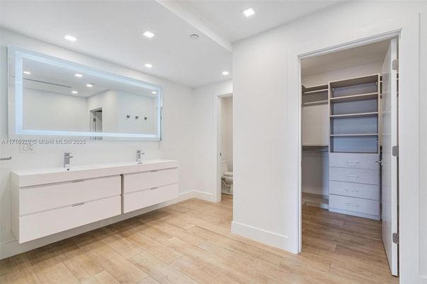 Bathroom, Dual Sink Vanities, Interior, Recessed Lighting, Walk-in Closets, Wood Texture Flooring