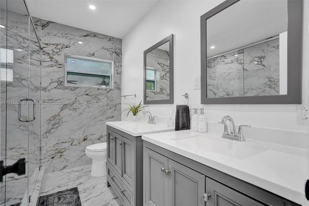 Bathroom, Dual Sink Vanities, Glass Shower, Interior, Marble, Marble Walls, Recessed Lighting
