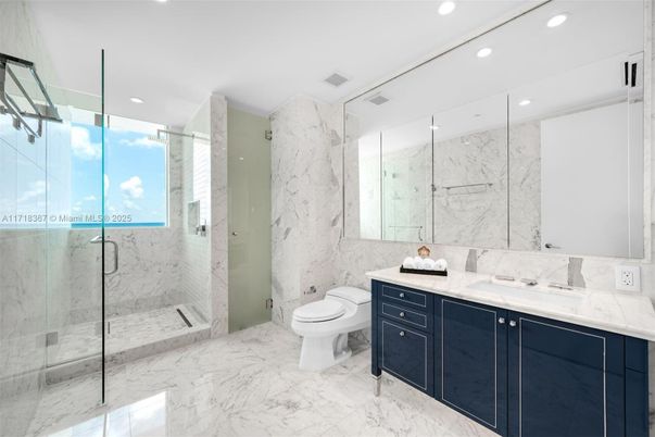 Bathroom, Dual Sink Vanities, Glass Shower, Interior, Marble, Marble Walls, Recessed Lighting