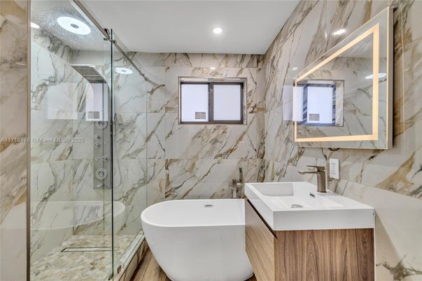 Bathroom, Free Standing Baths, Glass Shower, Interior, Marble Walls, Recessed Lighting