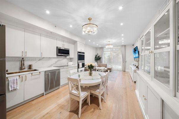 Chandelier, Dining room, Interior, Kitchen, Marble Walls, Recessed Lighting, Stainless Steel Appliances, Wood Texture Flooring