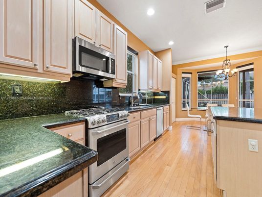 Chandelier, Dining room, Interior, Kitchen, Recessed Lighting, Stainless Steel Appliances, Wood Texture Flooring