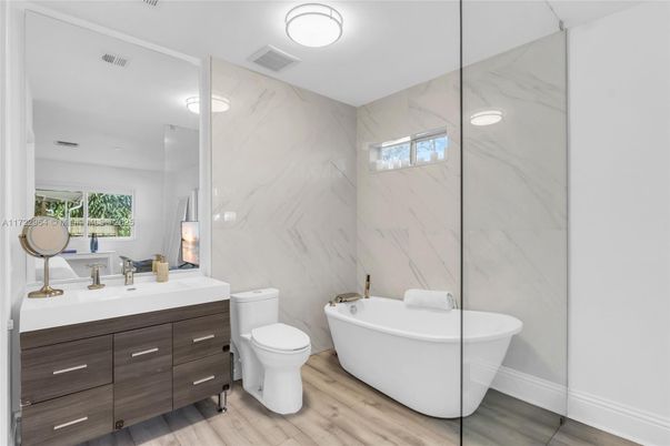 Bathroom, Dual Sink Vanities, Free Standing Baths, Glass Shower, Interior, Marble Walls, Wood Texture Flooring