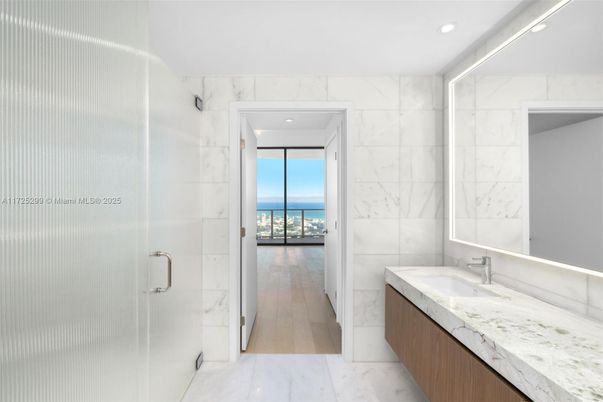 Bathroom, Glass Shower, Interior, Marble, Marble Walls, Recessed Lighting, Water, Wood Texture Flooring