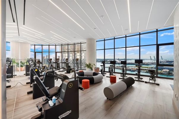Fitness Equipment, Gym, Interior, Living room, Recessed Lighting, Water, Wood Texture Flooring
