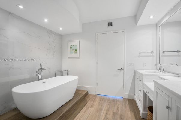 Bathroom, Dual Sink Vanities, Free Standing Baths, Interior, Marble Walls, Recessed Lighting, Wood Texture Flooring