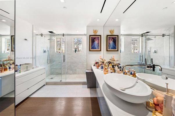 Bathroom, Dual Sink Vanities, Glass Shower, Interior, Marble Walls, Recessed Lighting, Wood Texture Flooring