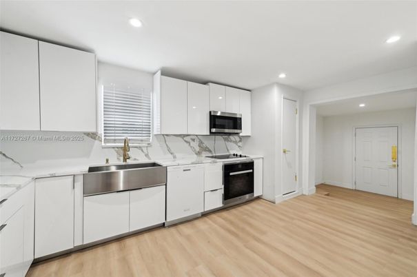 Interior, Kitchen, Marble Walls, Recessed Lighting, Stainless Steel Appliances, Wood Texture Flooring