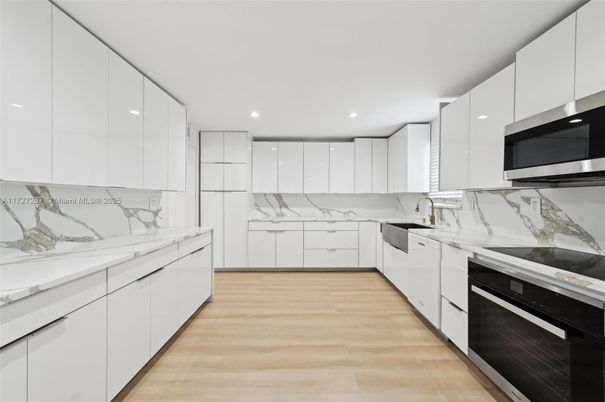 Interior, Kitchen, Marble Walls, Recessed Lighting, Stainless Steel Appliances, Wood Texture Flooring