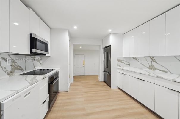 Interior, Kitchen, Marble Walls, Recessed Lighting, Stainless Steel Appliances, Wood Texture Flooring