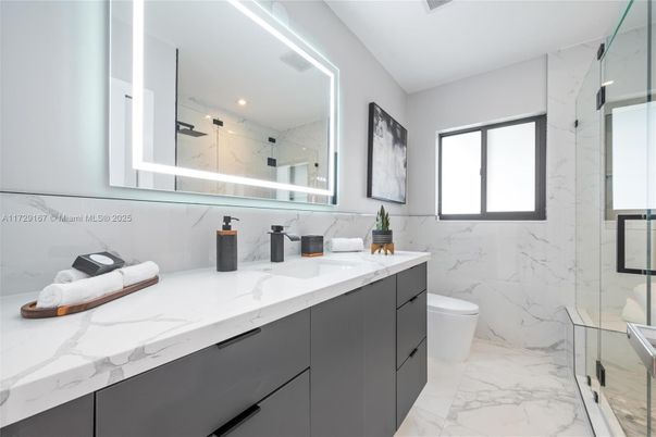 Bathroom, Dual Sink Vanities, Glass Shower, Interior, Marble, Marble Walls, Recessed Lighting
