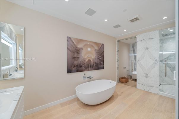 Bathroom, Dual Sink Vanities, Free Standing Baths, Glass Shower, Interior, Marble Walls, Recessed Lighting, Wood Texture Flooring