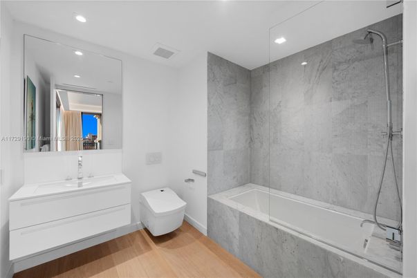 Bathroom, Glass Shower, Interior, Marble Walls, Recessed Lighting, Wood Texture Flooring