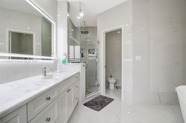 Bathroom, Dual Sink Vanities, Glass Shower, Interior, Marble, Marble Walls, Recessed Lighting