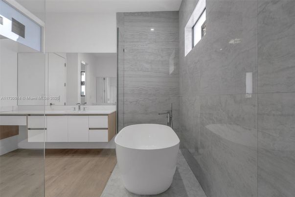 Bathroom, Dual Sink Vanities, Free Standing Baths, Glass Shower, Interior, Marble Walls, Wood Texture Flooring