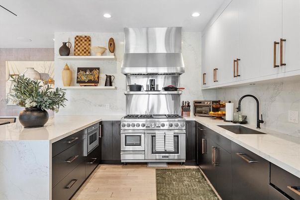 Interior, Kitchen, Marble Walls, Recessed Lighting, Stainless Steel Appliances, Wood Texture Flooring