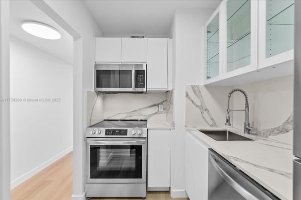 Interior, Kitchen, Marble Walls, Recessed Lighting, Stainless Steel Appliances, Wood Texture Flooring