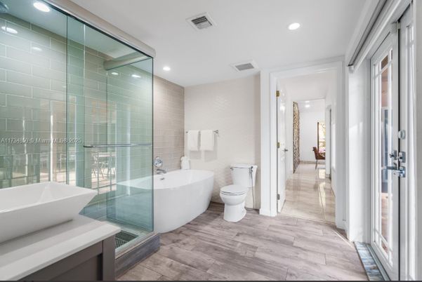 Bathroom, Free Standing Baths, Glass Shower, Interior, Recessed Lighting, Wood Texture Flooring