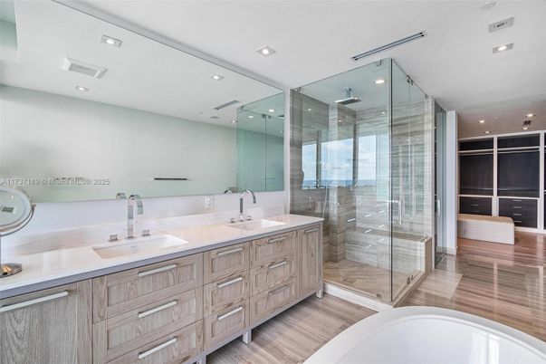 Bathroom, Dual Sink Vanities, Glass Shower, Interior, Recessed Lighting, Wood Texture Flooring