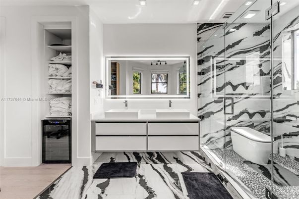 Bathroom, Dual Sink Vanities, Glass Shower, Interior, Marble, Marble Walls, Recessed Lighting, Wood Texture Flooring