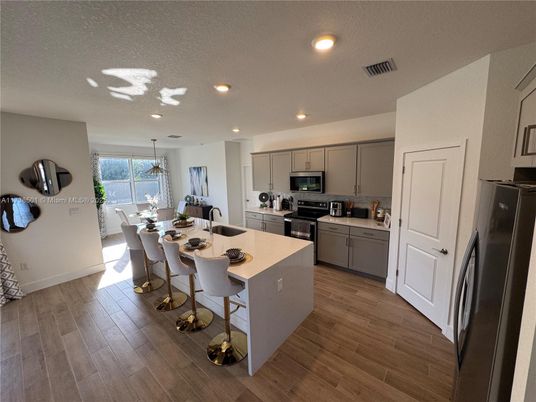 Chandelier, Dining room, Interior, Kitchen, Recessed Lighting, Stainless Steel Appliances, Wood Texture Flooring